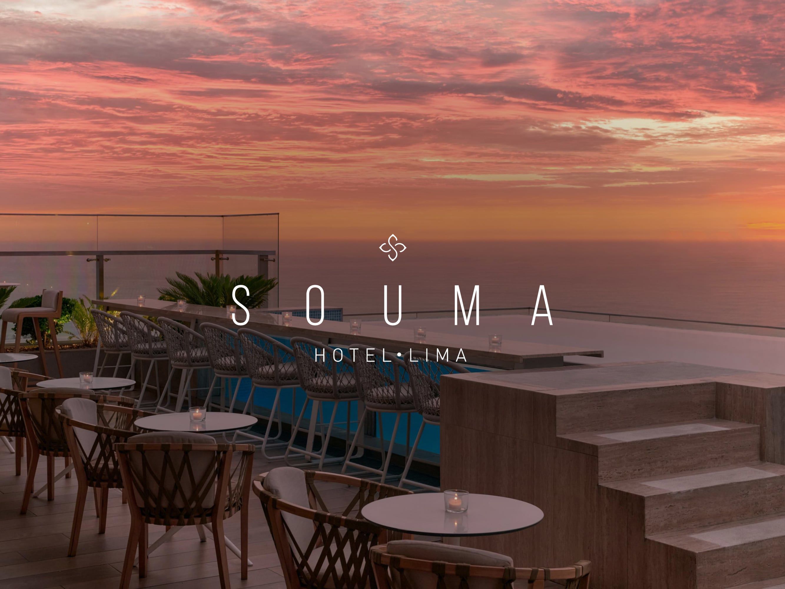 Rooftop terrace overlooking the ocean at sunset, with beautiful pink and orange sky; ‘SOUMA Hotel Lima’ logo overlaid